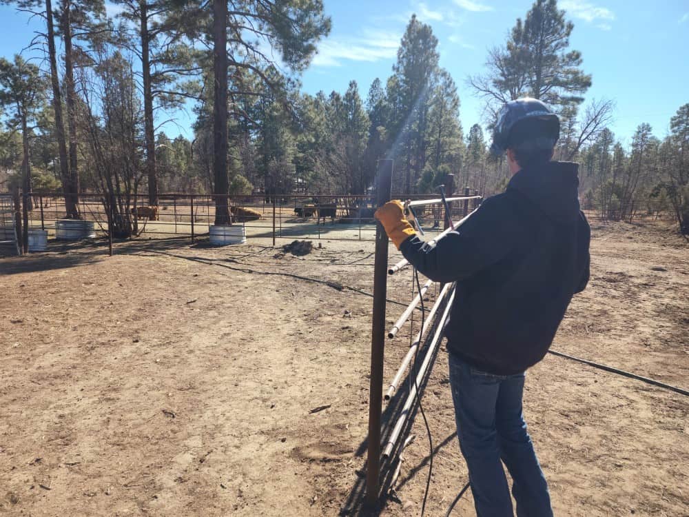 Erik measuring and leveling fence panel