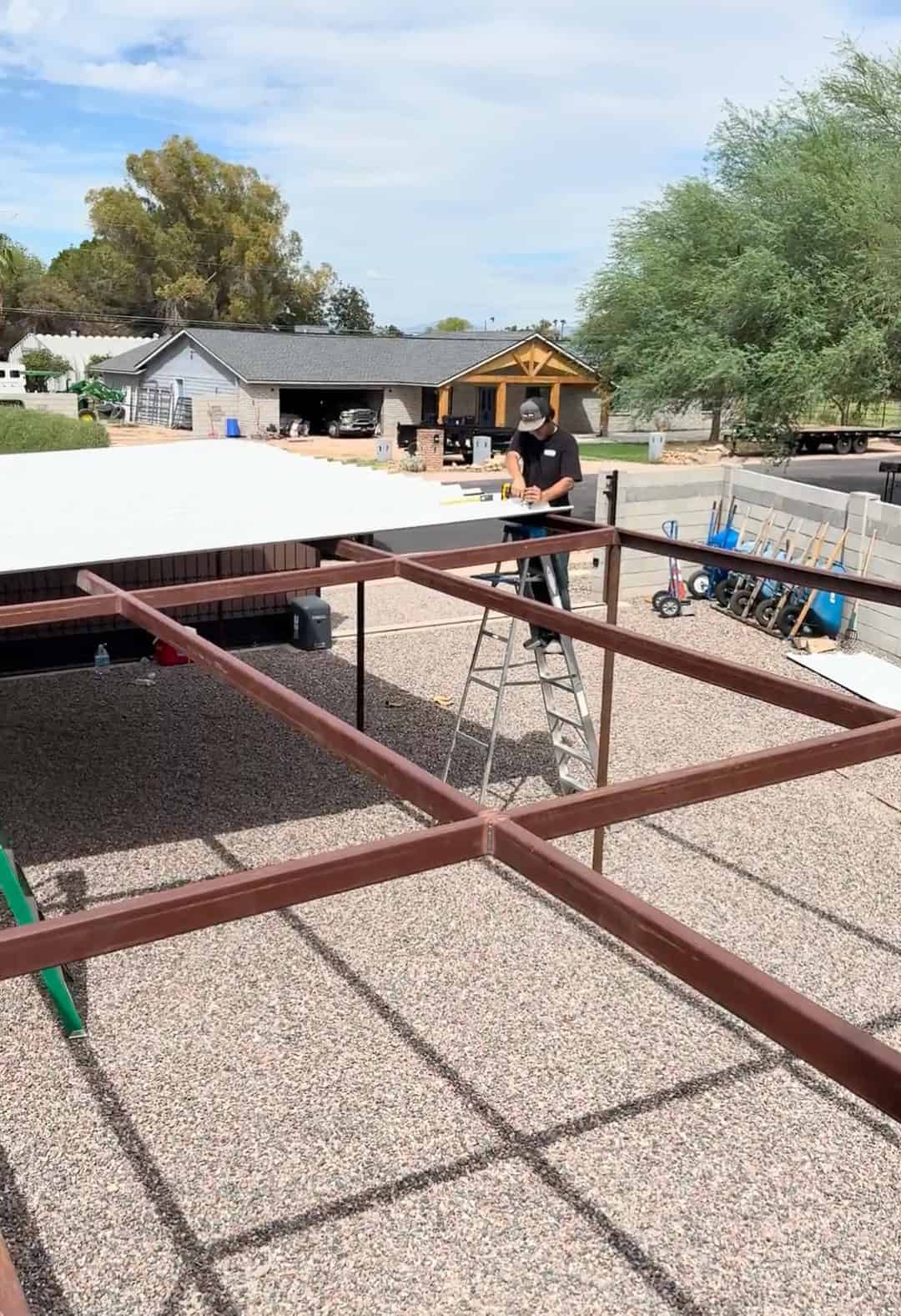 Mobile METAL Medics building a custom metal shade structure with pipe framing and PBR metal roof panels.