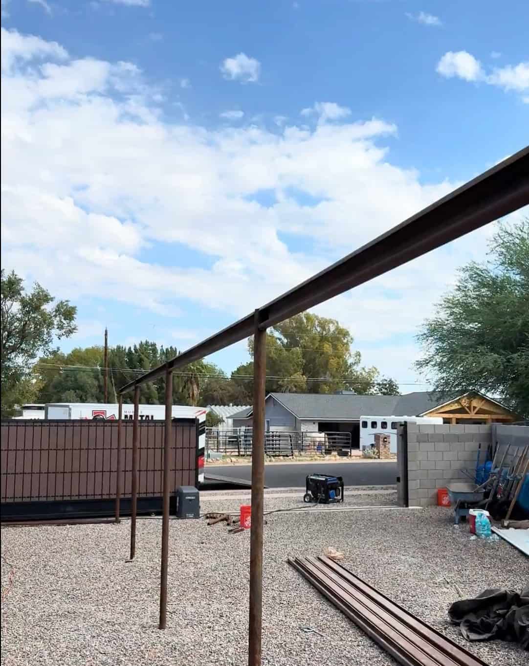 Partially assembled Mobile METAL Medics custom pipe shade structure with vertical posts and upper framing in place.